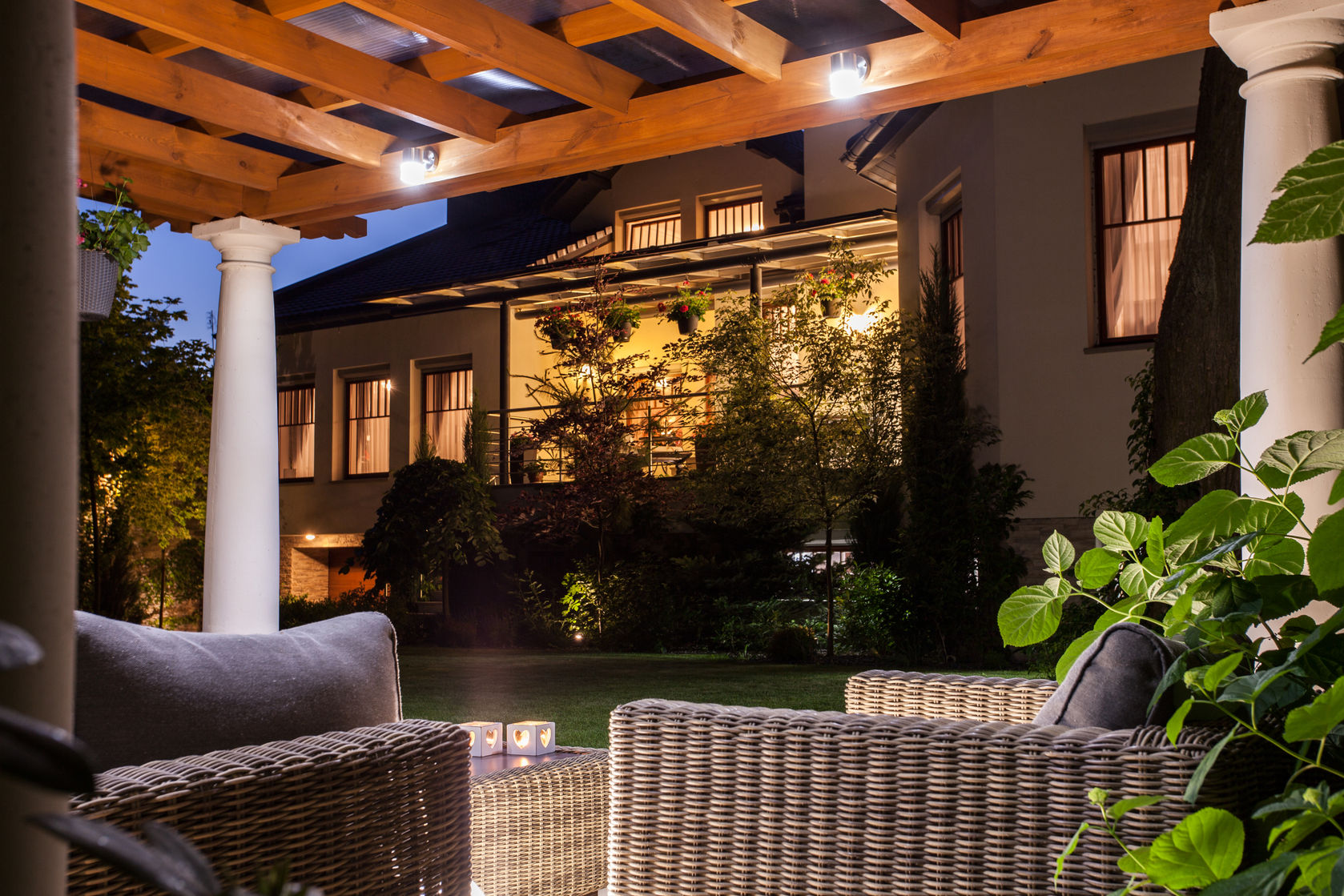 Landscape and patio lighting illuminating an outdoor living area after dark