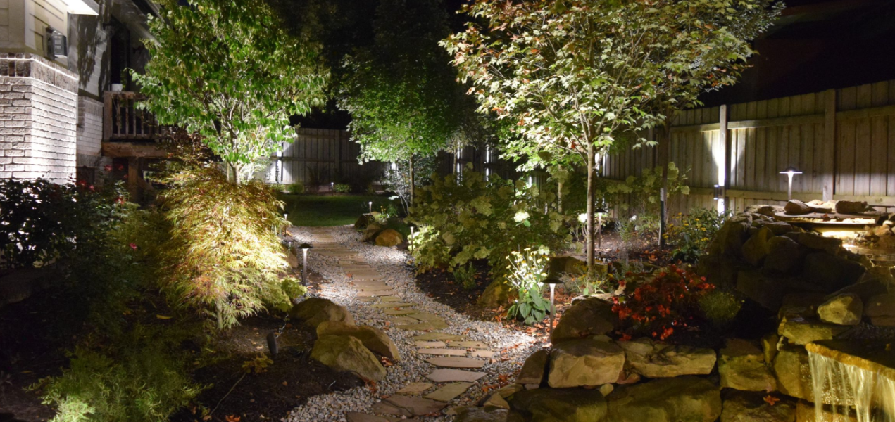 Path lighting illuminating a landscaped walkway